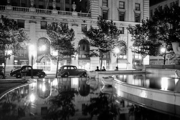 Manhattan: 1930s Night Scene 5Th Avenue Tree Lined Sidewalk Cars Anonymous Silhouetted Men Reflecting Water In Pulitzer Fountain NYC USA by Vintage Images