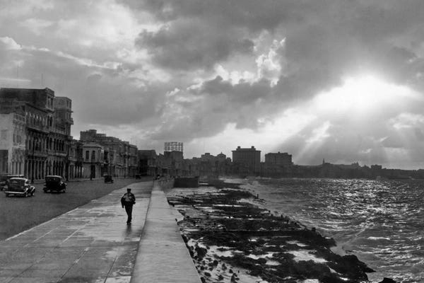 Silhouettes: 1930s-1940s Anonymous Silhouetted Man Walking Along Havana Sea Wall At Sunset Cuba by Vintage Images