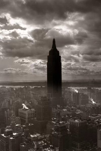 Empire State Building: 1930s-1940s Empire State Building Silhouetted Against High Gathering Storm Clouds Covering NYC New York USA by Vintage Images