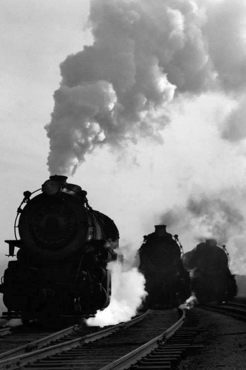 1930s-1940s Head-On View Of Three Steam Engines Silhouetted Against Billowing Smoke And Steam Outdoor