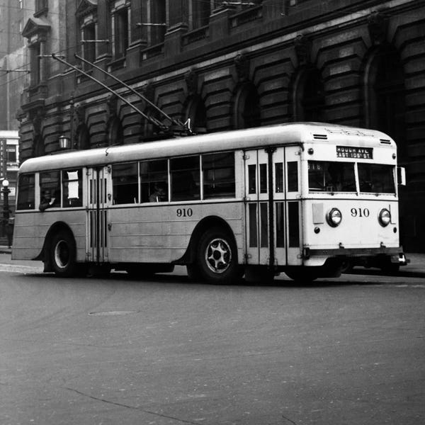 1930s-1940s Public Transportation Trackless Trolley Electric Bus About To Round Street Corner Cleveland Ohio USA