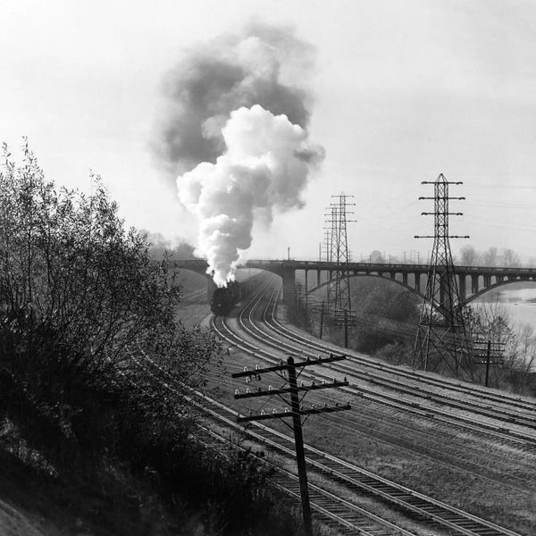 Railroads: 1940s Aerial Of Train Traveling Along River Under Bridge Billowing Smoke Near Columbus Ohio by Vintage Images