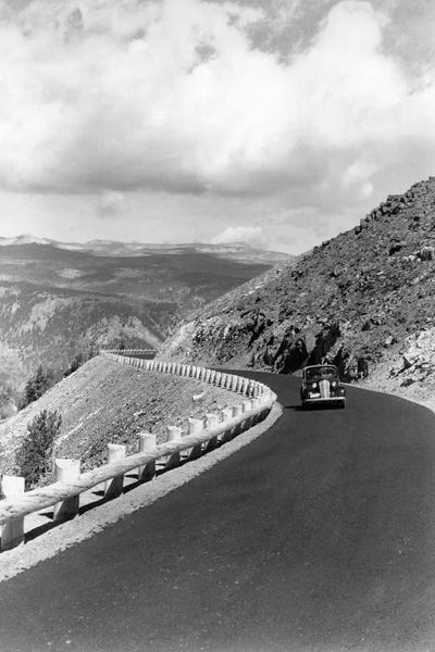 Montana: 1940s Automobile On Hillside Road Near Yellowstone National Park 11000 Feet Elevation Red Lodge Cooke City Montana USA by Vintage Images