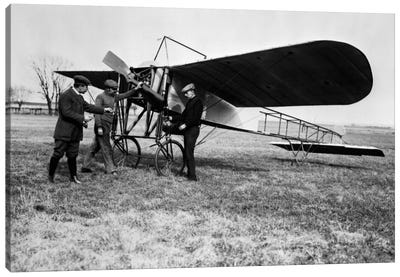 1910s Group Of Three Men Standing In Front Of Early Monoplane One With Hand On Propeller Canvas Art Print - Airplane Art