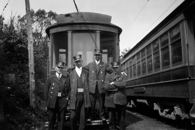 1910s-1920s 4 Men Conductors Motormen Public Transportation Transit Workers Posing In Front Of Trolley Car In Uniforms And Hats