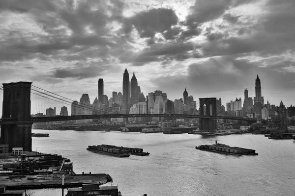 1940s-1950s Sunset Downtown New York City Skyline With Brooklyn Bridge Barges In East River NYC, NY, USA