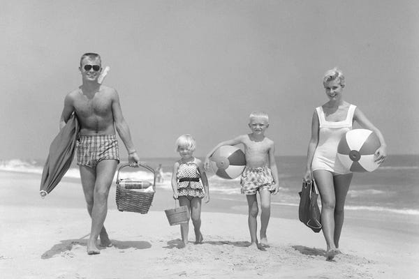 Women's Swimsuits: 1950s Family Of Four Walking Towards Camera With Beach Balls Umbrella Picnic Basket And Sand Bucket by Vintage Images