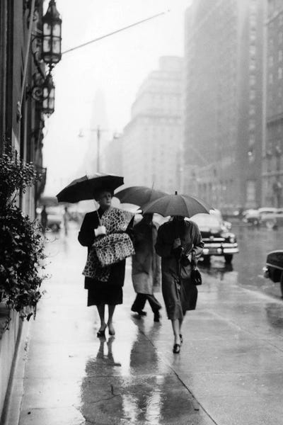 1950s Fashionable Woman Wearing Leopard Skin Muff And Stole Walking Down Rainy City Street