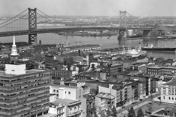 Pennsylvania: 1950s Philadelphia PA USA Looking Northeast Past Delaware River Waterfront To Benjamin Franklin Suspension Bridge To Camden NJ by Vintage Images