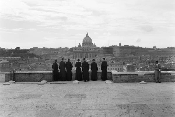 Vintage Images: 1950s Rome Italy Back View Of Student Priests Lined Up By Wall Overlooking City With View Of St. Peters Basilica In Background by Vintage Images