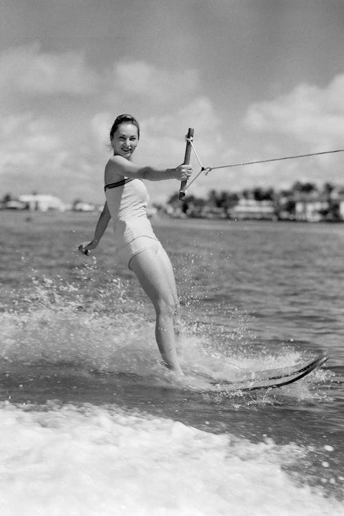 1950s Smiling Woman In Bathing Suit Water Skiing Waving One Hand Looking At Camera