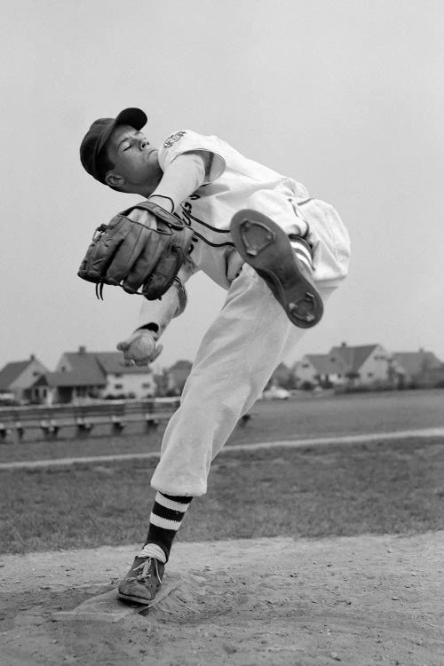 1950s Teen In Baseball Uniform Winding Up For Pitch