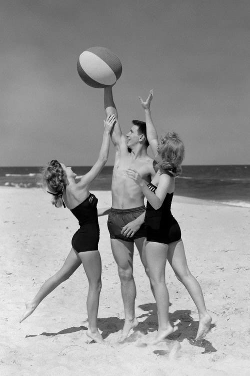 1950s Teens Jumping For Beach Ball Wearing Swim Suits