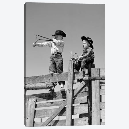 1950s Two Young Boys Dressed As Cowboys Shooting Slingshots On Top Of Wooden Fence Outdoor Canvas Print #VTG361} by Vintage Images Canvas Print