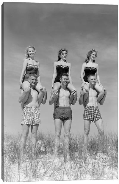 1950s-1960s Three Couples At Beach On Dunes With Women In Identical Bathing Suits Sitting On Men's Shoulders Canvas Art Print - Vintage & Retro Photography