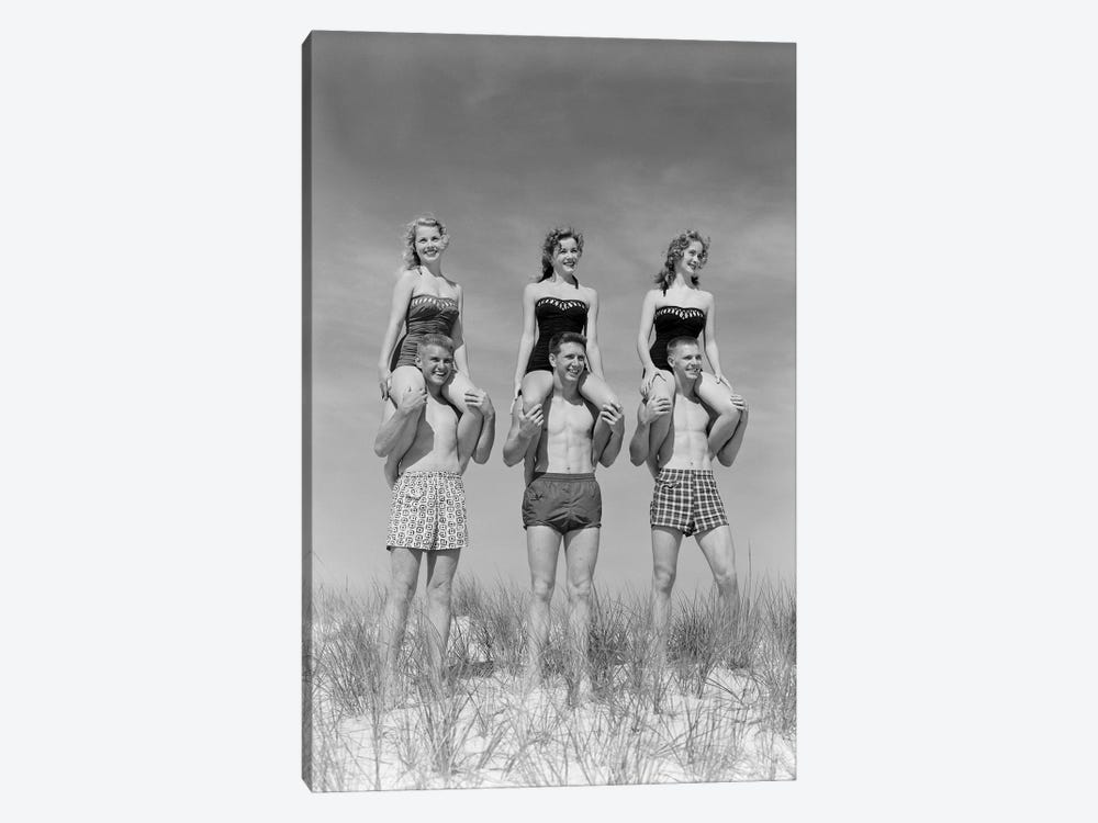 1950s-1960s Three Couples At Beach On Dunes With Women In Identical Bathing Suits Sitting On Men's Shoulders by Vintage Images 1-piece Canvas Artwork