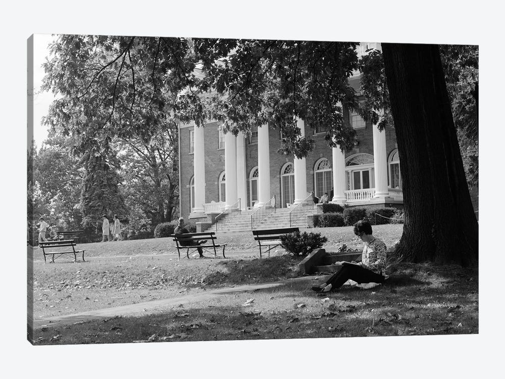 1960s Anonymous Silhouetted Female College Student Sitting Under Tree Studying With Campus Building In Background by Vintage Images 1-piece Canvas Print
