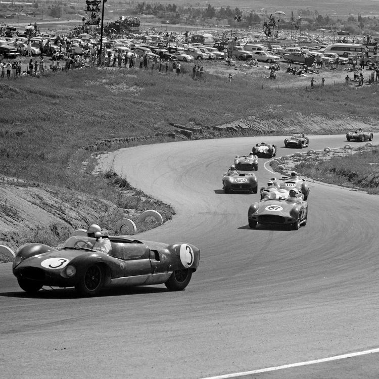 1960s Auto Race On Serpentine Section Of Track With Spectators Watching From Small Hill