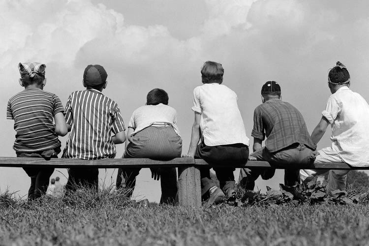 1960s Back View Of Six Anonymous Boy Baseball Players Sitting On Bench