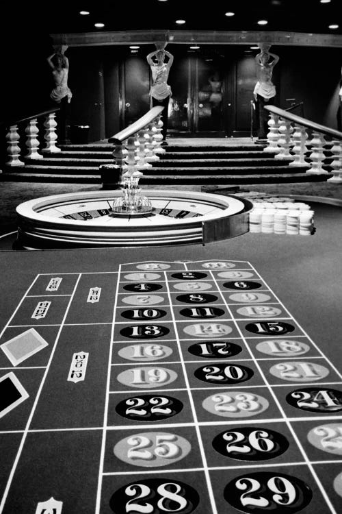 1960s Casino Viewed From End Of Roulette Table Opposite Of Wheel Looking Toward Statues Of Female Showgirls