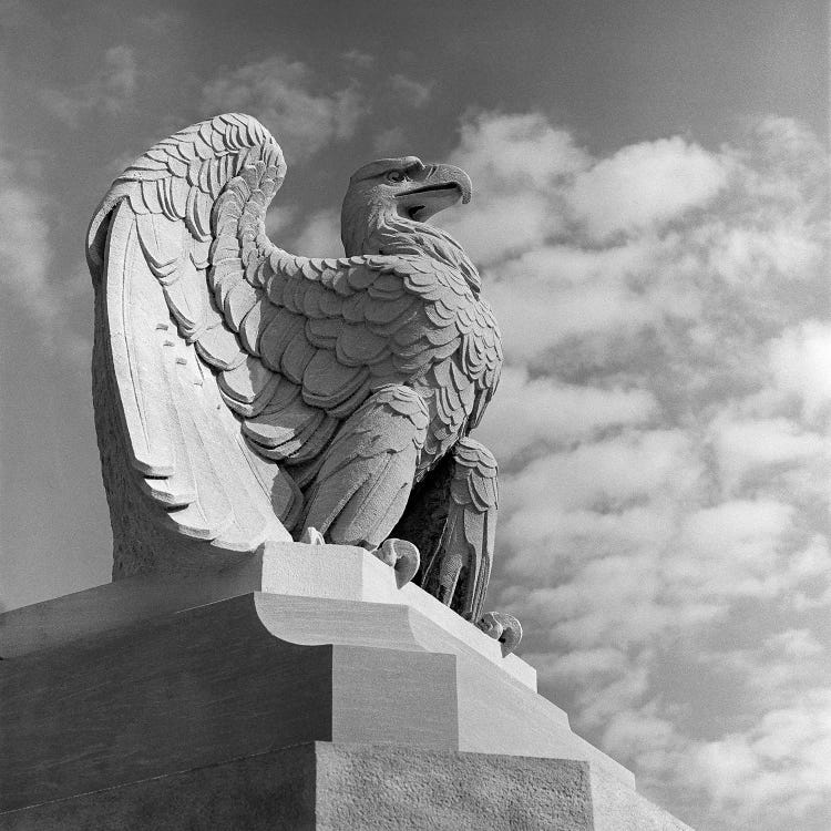 1960s Eagle Statue Against Sky Clouds Wings Spread Feathers Talons Curled Over Edge Of Base Philadelphia 30th Street