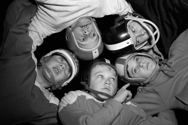 1960s Five Boys In Huddle Wearing Helmets & Football Jerseys The View Is From Inside The Huddle Looking Up