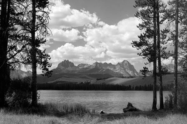 Idaho: 1960s Little Red Fish Lake In Idaho With Saw Tooth Mountains In Background Viewed Between Clearing In Trees by Vintage Images