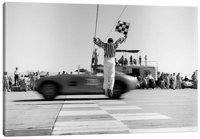 1960s Man Jumping Waving Checkered Flag For Winning Sports Car Crossing The Finish Line Canvas Art Print - Action Shot Photography