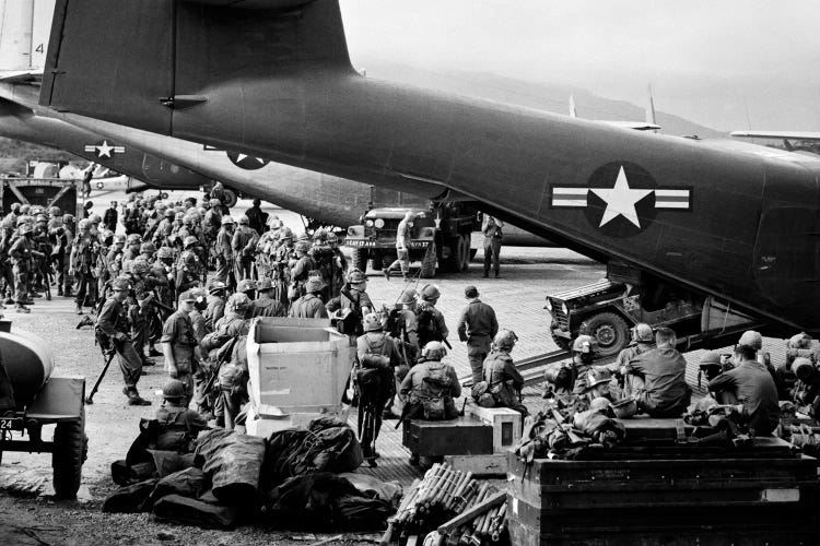 1960s Military Personnel Gathered Under Tails Of Planes In Airfield Waiting To Be Airlifted For Special Operation In Vietnam