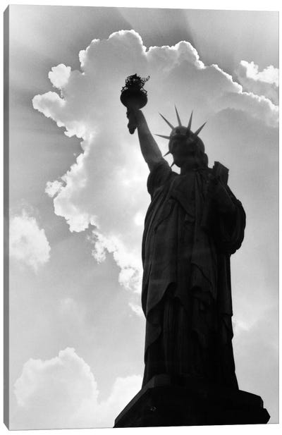 1960s Silhouette Of Statue Of Liberty With Sun Ray Clouds Behind Canvas Art Print - Famous Monuments & Sculptures