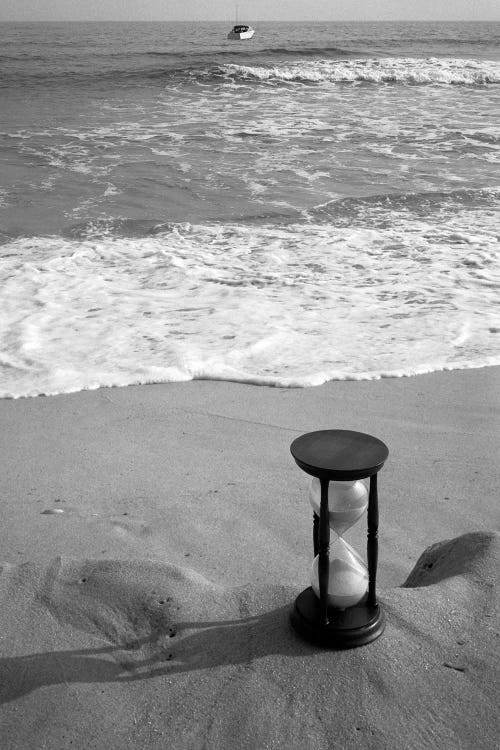 1960s Still Life Of Hourglass At Edge Of Beach Sand With Waves Washing Up On Shore And Power Boat Passing Offshore Tempus Fugit