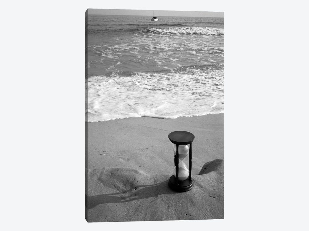 1960s Still Life Of Hourglass At Edge Of Beach Sand With Waves Washing Up On Shore And Power Boat Passing Offshore Tempus Fugit by Vintage Images 1-piece Canvas Art