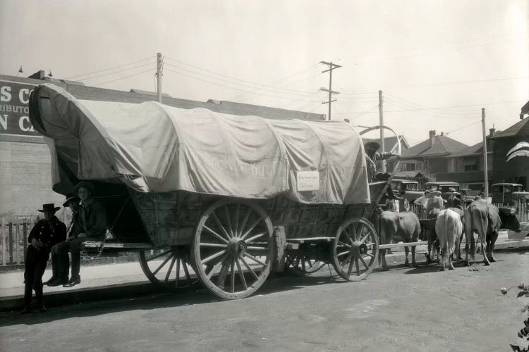 1920s Ox Drawn Conestoga Covered Wagon Parked Along Street