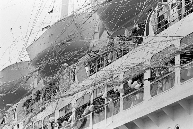 1970s Crowd Gathered On 2 Levels Of Deck Of Large Departing Cruise Ship Waving Pompoms With Paper Streamers Blowing