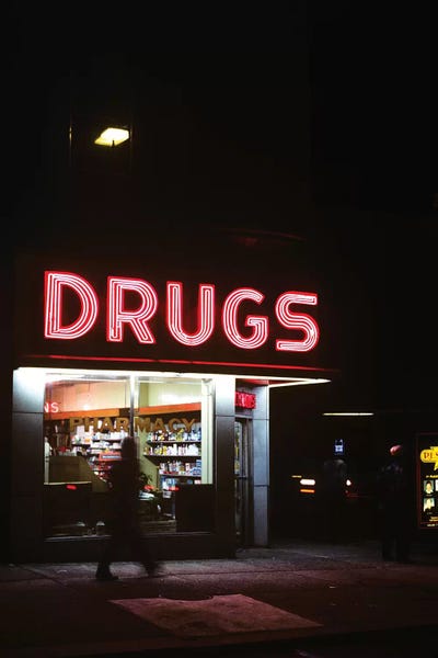 The Eighties: 1980s Drug Store At Night Pink Neon Sign Drugs by Vintage Images