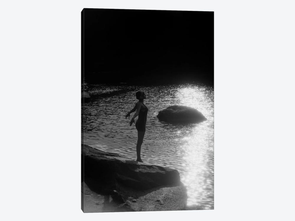 1920s Sunset Silhouette Of Anonymous Woman Standing On A Rock Near Water About To Dive In by Vintage Images 1-piece Canvas Art Print