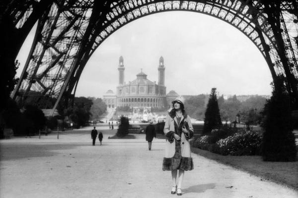 Paris Photography: 1920s Woman Walking Under The Eiffel Tower With The Trocadero In Background Paris France by Vintage Images