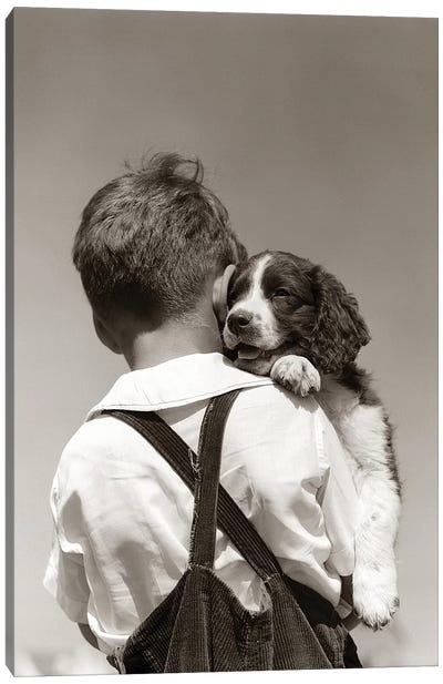 1930s-40s Back View Of Boy In Corduroy Overalls Holding Springer Spaniel Puppy Canvas Art Print
