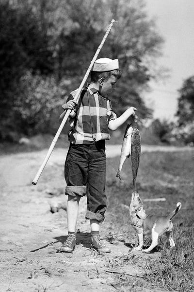 1950s Boy Plaid Shirt Sailor Hat Fishing Pole Dog Pulling On Tail Of Caught Fish by Vintage Images canvas print