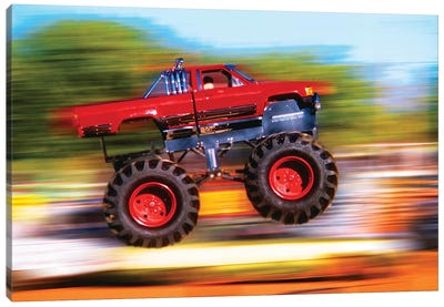 Big Wheeled Red Truck Jumping Blurred Background Canvas Art Print - Action Shot Photography