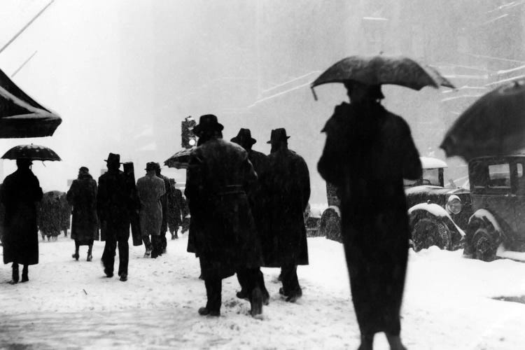 1920s-1930s Crowd Of Anonymous Pedestrians Silhouetted By Snow Storm Walking On City Street Sidewalk