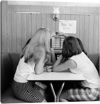 1960s Four Teenage Girls Putting Coins In Slot Of Small Individual Juke Box Of Diner Soda Shop Canvas Art Print - Authenticity