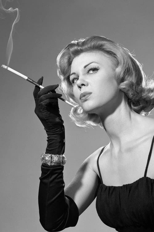 1960s Sexy Sultry Woman In Black Evening Dress Long Black Gloves Bracelet Smoking Cigarette In Long Cigarette Holder