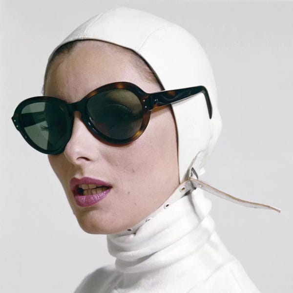 Eyewear: 1970s Portrait Smiling Woman Wearing Designer Fashion White Turtle Neck Leather Aviator Helmet Large Tortoise Shell Sunglasses by Vintage Images