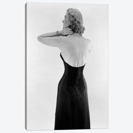 1950S Blonde Woman Wearing Black Strapless Gown Hands And Arms Reaching To Her Neck Canvas Print #VTG666} by Vintage Images Art Print