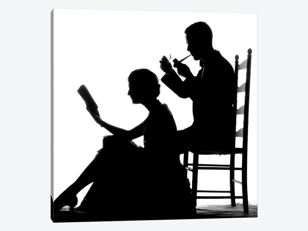 1920s 1930s Anonymous Silhouetted Man In Ladder-Back Chair Smoking Pipe With Woman Seated On Floor In Front Of Him Reading Book by Vintage Images 1-piece Canvas Art