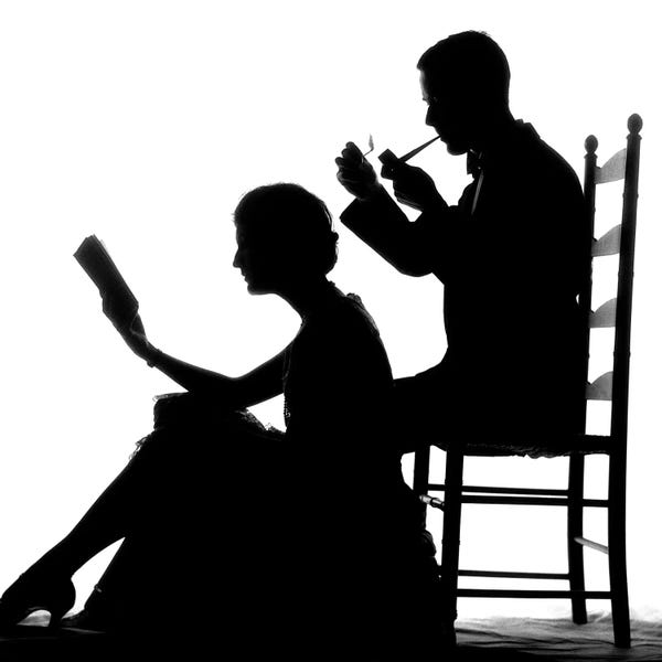 Vintage Images: 1920s 1930s Anonymous Silhouetted Man In Ladder-Back Chair Smoking Pipe With Woman Seated On Floor In Front Of Him Reading Book by Vintage Images