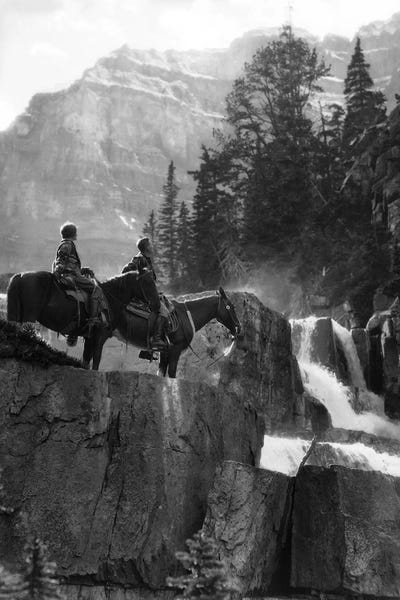 Alberta: 1920s 1930s Couple Man Woman On Horses By Waterfall In Pine Forest Giants Steps Paradise Valley Alberta Canada by Vintage Images