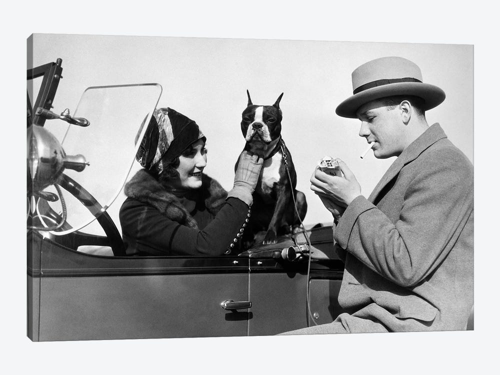 1920s Woman Sitting In Driver's Seat Convertible Car With Boxer Dog Man Lighting Cigarette by Vintage Images 1-piece Art Print