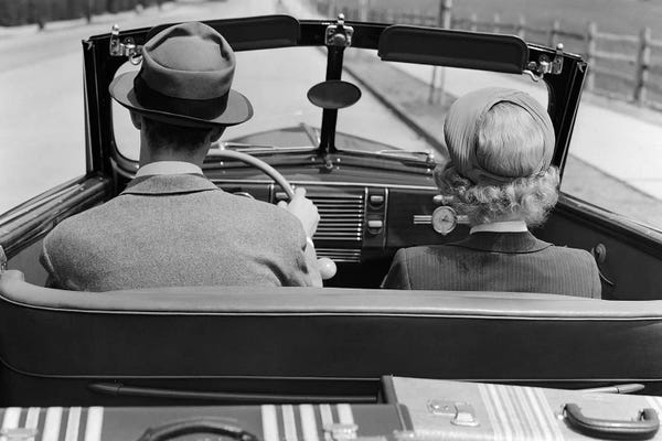 Vintage & Retro Photography: 1930s 1940s Rear View Couple Driving Together In Convertible Luggage In Back Seat by Vintage Images